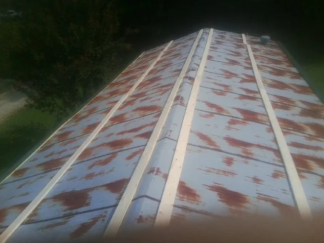Rusted metal roof panels with new wood purlins before replacement — Storm Damage Roof Repair in Lawrence Township by Roofing Brothers